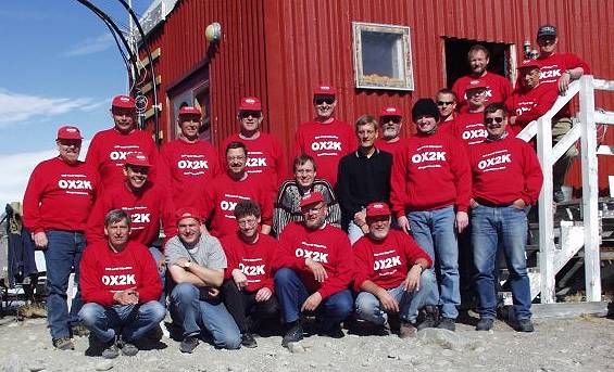 A happy team at the end of a successful expedition. On the stairs: Holger, OX3HI; Steen, OZ2TG; Michael, OX3LG.Back: Benny, OZ5RZ; Jan, OZ5ZF, Ole, OX3OX; Peter, OZ1CBW, J�rgen, OZ1JSH, Ivan, OZ5IR; Rune; Frank, OZ1FQ.Middle: Knud, OZ1FIT; Frits, OZ2Q; Uffe, PA5DD; S�ren, OZ1FTU; Bo, OZ2M;Peter, OZ1PIF.Front: Steen, OZ3SW; Bo, OX3LX; J�rgen, OZ1BNN, Kurt, OZ7YK; Ole, OZ7FI.