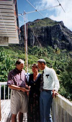 OH2BR presenting the SRAL pennant to his hosts Tom, VP6TC and Betty, VP6YL on their balcony, following his successful operation as VP6BR. The photo also shows the six-metre yagi in its new location, with Fletcher Christian�s Cave in the background.